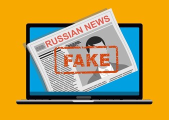 laptop with newspaper with Russian fake news.