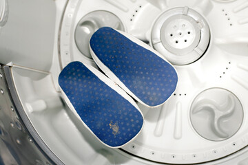 dirty blue baby shoes insdie washing machine