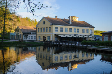 Fototapeta na wymiar Beautiful building with reflection from a river from Fiskars Finland
