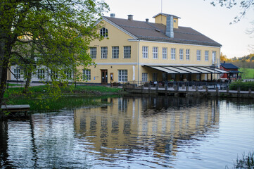 Fototapeta na wymiar Beautiful building with reflection from a river from Fiskars Finland