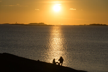 Naklejka na ściany i meble Two girls in front of beautiful sunset