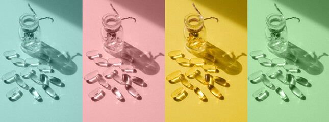 Pills and glass pill bottle on multi colored background. Big tablets. Omega 3 capsules. Close up,...
