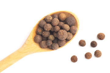 Spice Allspice in wooden spoon and bunch on white background. Macro. Flat lay. Diet concept