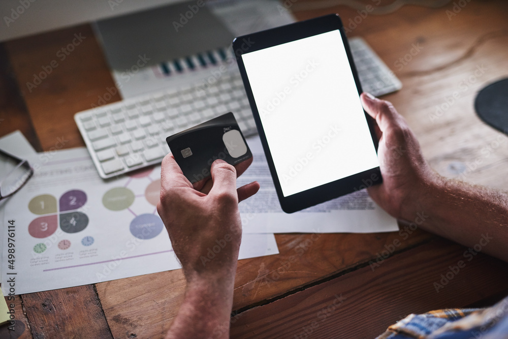 Aufkleber Well deliver right to your desk. Shot of an unidentifiable programmer holding his credit card while using his tablet in the office.