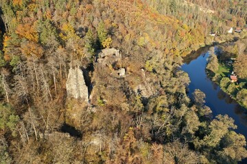Old medieval castle ruins on the rock over the blue river bend