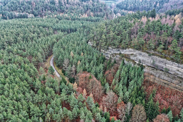 Deep forests of Ralsko military area with single road and steep rocks