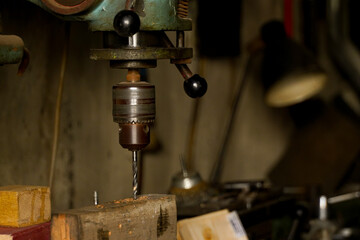 drill. drill in a workshop. detail. indoor photo in natural light.