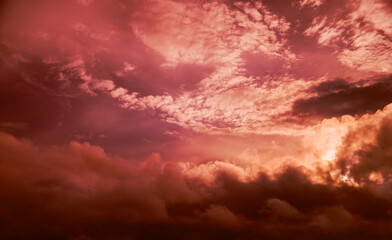 Red cloudy sky at sunset, toned photo.