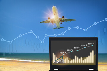 Commercial plane ready for landing or taking off with growth graph on computer notebook. Airplane business recovery concept and return on investment idea