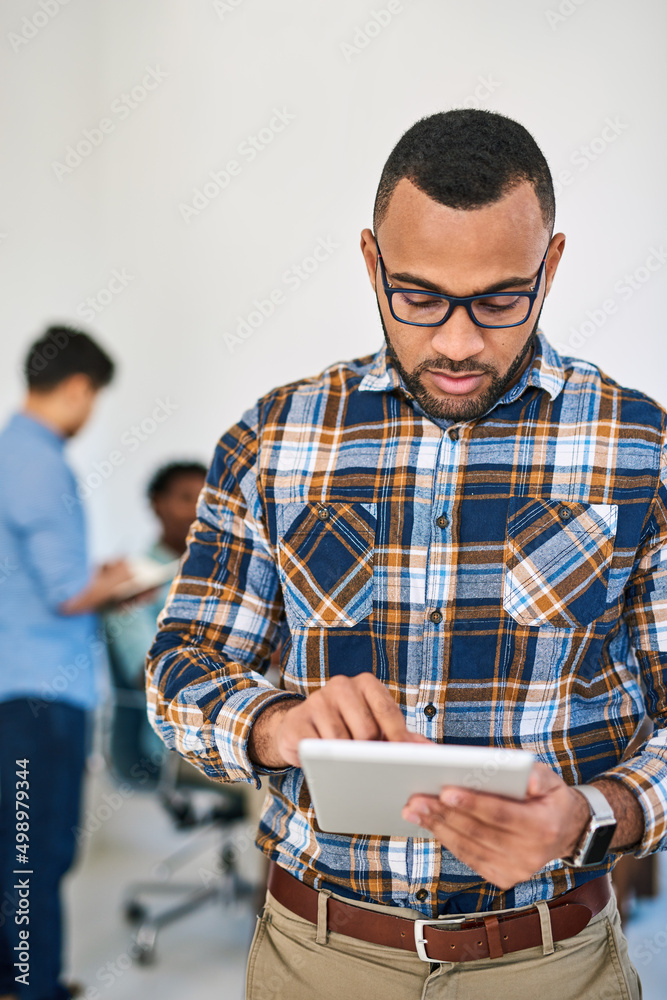 Aufkleber meeting his managerial tasks with modern tech. shot of a young entrepreneur using a digital tablet a