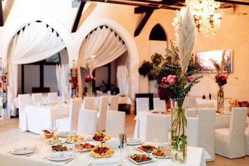 bright banquet hall tables set white tablecloth