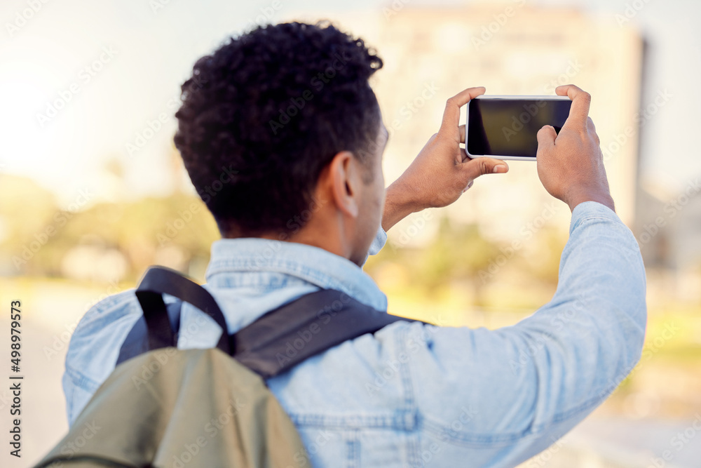 Poster i cant wait to share these beautiful sights. shot of a man taking pictures while out in the city.