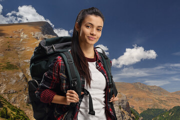 Naklejka premium Young female hiker with a backpack
