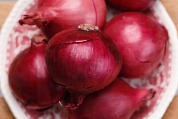 red onion in the husk on a plate.
