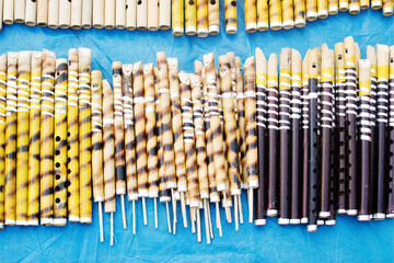 KOLKATA, WEST BENGAL , INDIA - NOVEMBER 23RD 2014 : Flutes made of slender bamboo, artworks of handicraft, on display during Handicraft Fair in Kolkata - the biggest handicrafts fair in Asia.