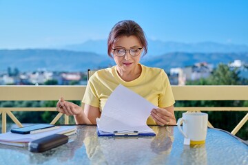 Portrait of business woman looking at webcam while sitting at home office desk