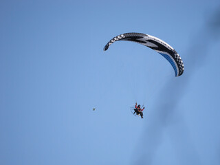 Paraglider flying with the blue sky in the background