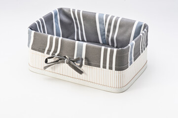 Rectangular white wooden basket, with gray striped cloth, isolated