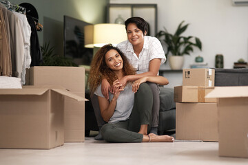 We both pitch in. Shot of a couple unpacking boxes in their new home.