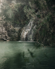 Beautiful nature waterfall with green water deep in the forest with a river view on the island of Cyprus