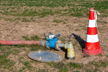 water meter with pump on the field - obrazy, fototapety, plakaty