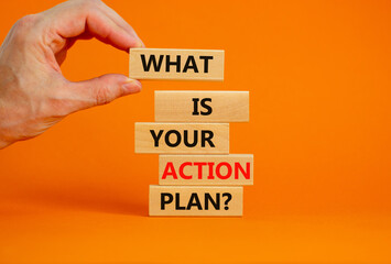 Action plan symbol. Concept words What is your action plan on wooden blocks. Businessman hand....