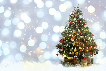 Beautifully decorated Christmas tree and gift boxes on blurred background, space for text. Bokeh effect