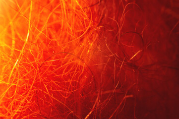Macro photo. Close-up abstract textile fiber red-orange color extreme macro in shallow depth of field. Abstract background