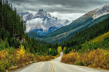 Empty road in the foreground and the Cathedral Mountain in the background in Yoho National Park,...
