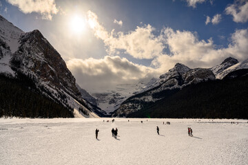 People walking on a frozen Lake Louise in Banff National Park