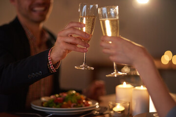 Love should be celebrated every day. Cropped shot of a young couple making a toast.