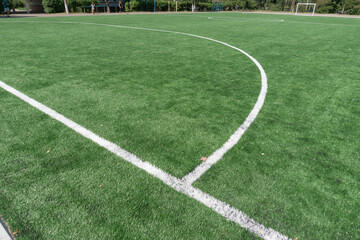 Fototapeta na wymiar Marking on a modern stadium with artificial turf. School stadium.