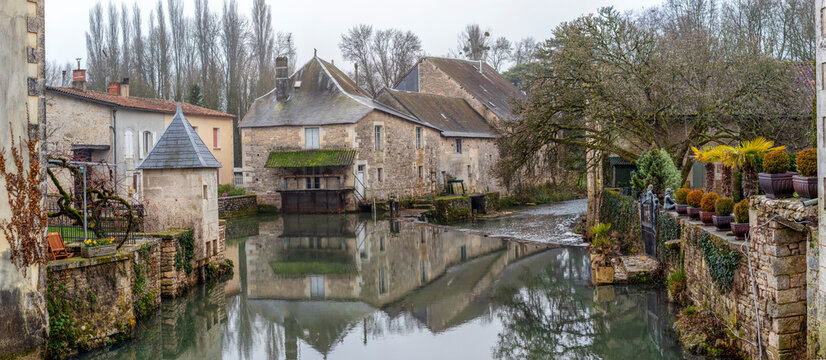 Verteuil sur Charente, french castle and river waterfront with mirror-like reflection, France