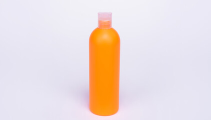 orange shampoo bottle isolated on white background, skincare