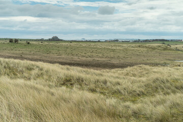 View across Holy island to Lindisfarne castle, Northumberland, UK