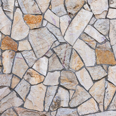 Obraz premium Old stone wall of stones of different sizes and colors as a natural background