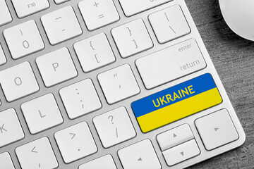 Button in colors of Ukrainian flag on keyboard, top view