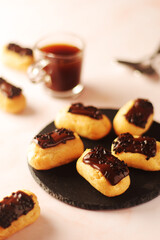 Traditional French dessert - eclairs with a cup of coffee