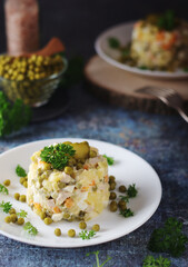 Olivier salad, traditional Russian dish, served on the plate	