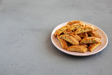 Homemade Italian Cantuccini with Pistachios and Citron on a Plate, side view. Crispy Pistachio and Citron Cookies. Copy space.