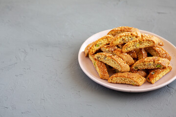 Homemade Italian Cantuccini with Pistachios and Citron on a Plate, side view. Crispy Pistachio and Citron Cookies. Space for text.