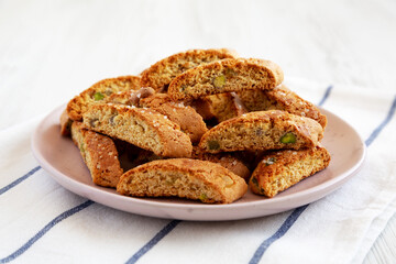 Homemade Italian Cantuccini with Pistachios and Citron on a Plate, side view. Crispy Pistachio and Citron Cookies. Close-up.