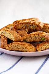 Homemade Italian Cantuccini with Pistachios and Citron on a Plate, side view. Crispy Pistachio and Citron Cookies. Close-up.