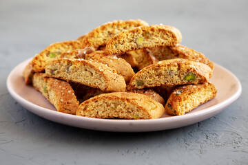 Homemade Italian Cantuccini with Pistachios and Citron on a Plate, side view. Crispy Pistachio and Citron Cookies.