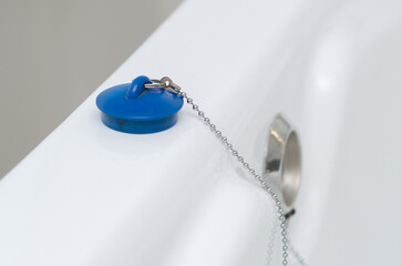 blue stopper on a bathroom chain