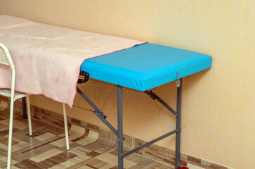 blue massage table in the room