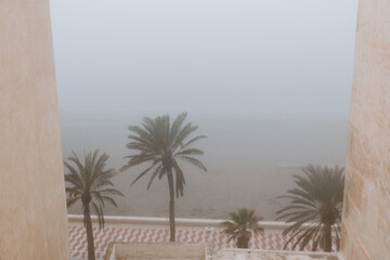 Views from the house of the beach and the promenade of Almería with fog.