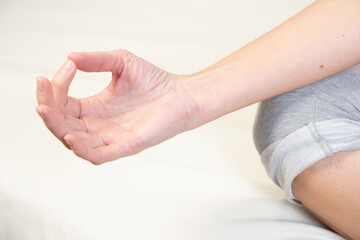 Close-up of woman's hands during a meditation session.