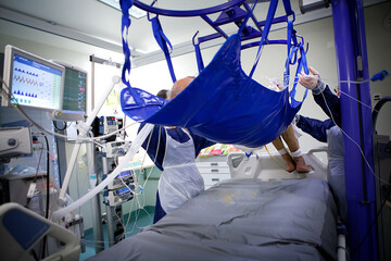 Weighing of a patient in the intensive care unit.