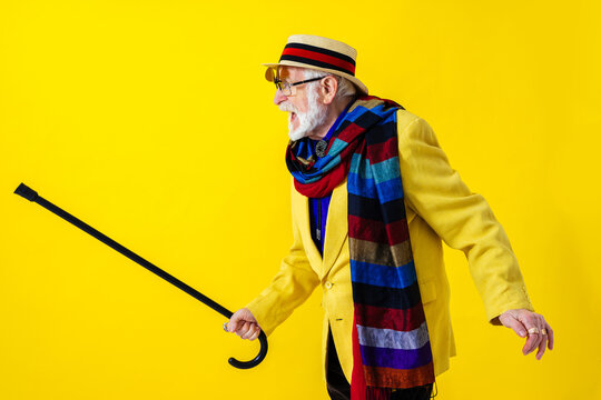 Cool senior man with fashionable outfit portrait - Funny old male person with cool and playful attitude on colorful background